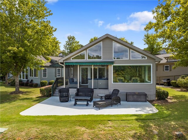 rear view of house featuring a yard and a patio area