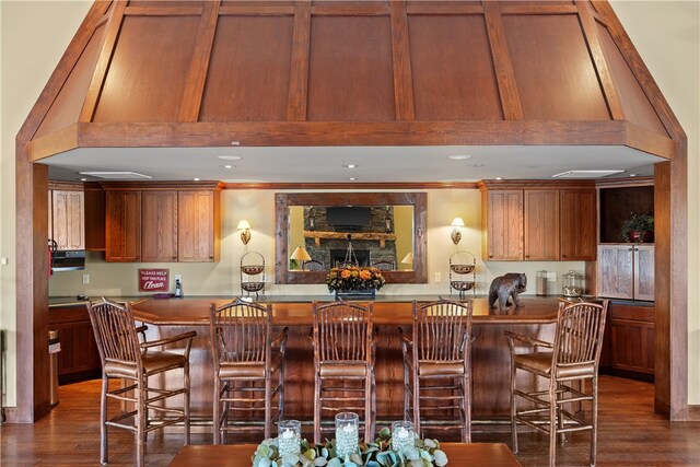 kitchen featuring kitchen peninsula, a kitchen breakfast bar, and dark hardwood / wood-style flooring