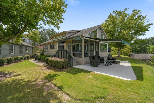 back of property with a yard and a patio