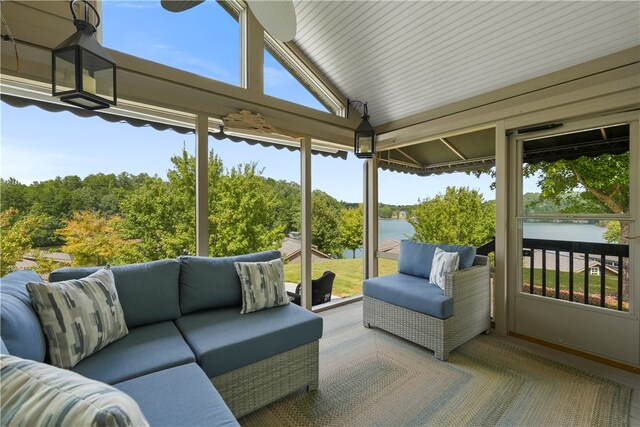 sunroom with a water view and vaulted ceiling