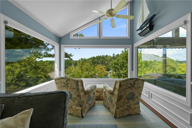 sunroom featuring lofted ceiling and ceiling fan