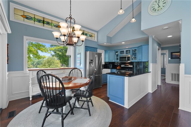 dining room with dark hardwood / wood-style flooring, high vaulted ceiling, and a notable chandelier