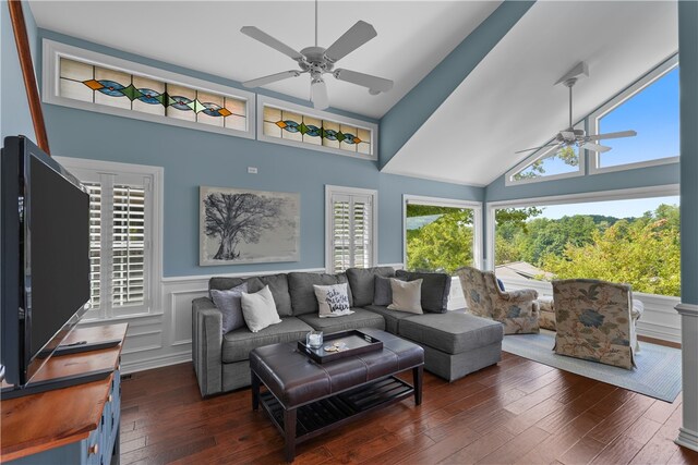 living room with dark wood-type flooring, ceiling fan, and high vaulted ceiling