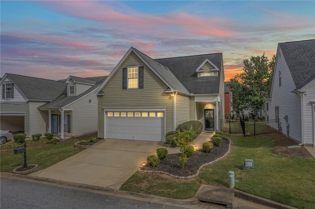 view of front of property featuring a lawn and a garage