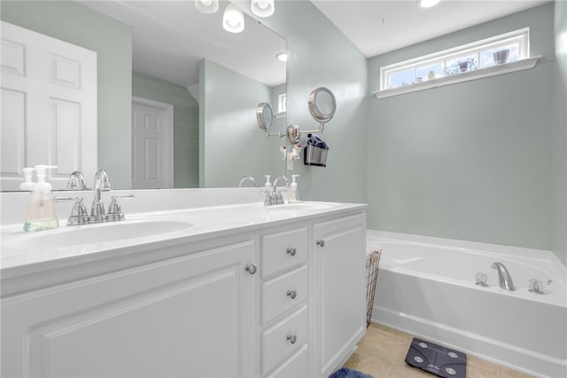 bathroom with a tub to relax in, tile patterned flooring, and vanity