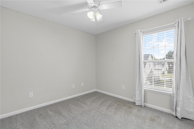 carpeted empty room featuring ceiling fan