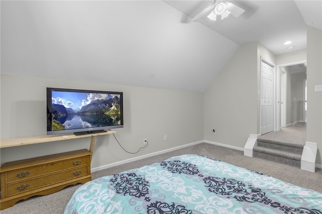 carpeted bedroom featuring a closet, lofted ceiling, and ceiling fan