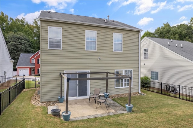 back of property with a garage, a patio, and a yard