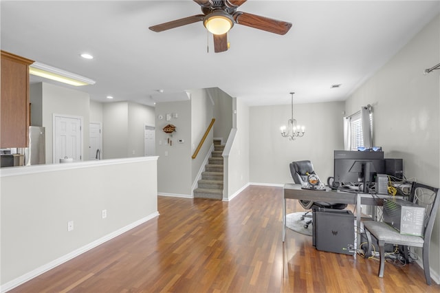 office space with ceiling fan with notable chandelier and dark hardwood / wood-style floors