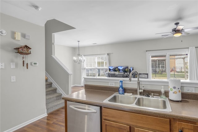 kitchen with hanging light fixtures, sink, stainless steel dishwasher, dark hardwood / wood-style floors, and ceiling fan with notable chandelier