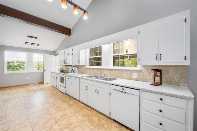 kitchen featuring beam ceiling, white appliances, white cabinetry, decorative backsplash, and a healthy amount of sunlight