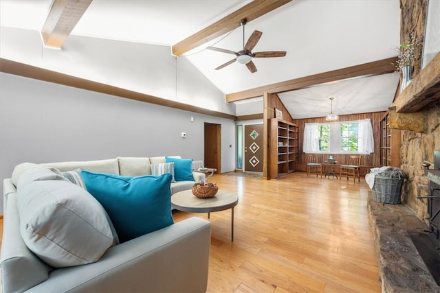 living room with vaulted ceiling with beams, light hardwood / wood-style floors, and ceiling fan