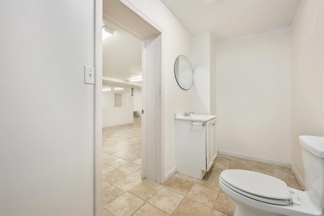 bathroom with tile patterned flooring, vanity, and toilet