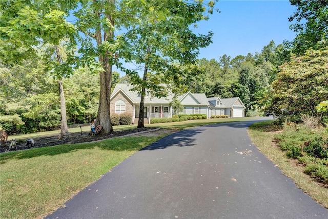 view of front of house with a garage and a front lawn