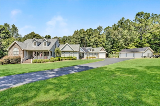 cape cod-style house with a front yard, an outdoor structure, a garage, and a porch