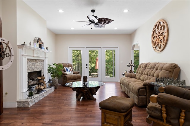 living room with ceiling fan and dark hardwood / wood-style flooring