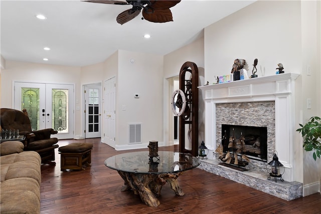 living room featuring french doors, ceiling fan, a fireplace, and dark hardwood / wood-style floors