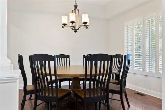 dining room with a chandelier and dark hardwood / wood-style floors