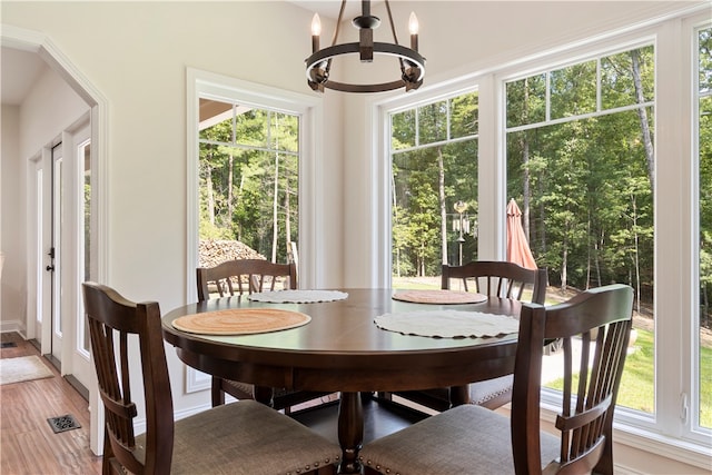 dining room featuring hardwood / wood-style flooring and an inviting chandelier