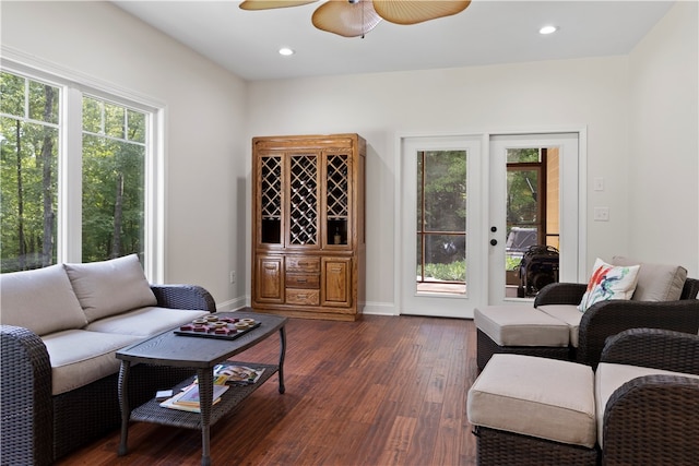 living room with ceiling fan and dark wood-type flooring