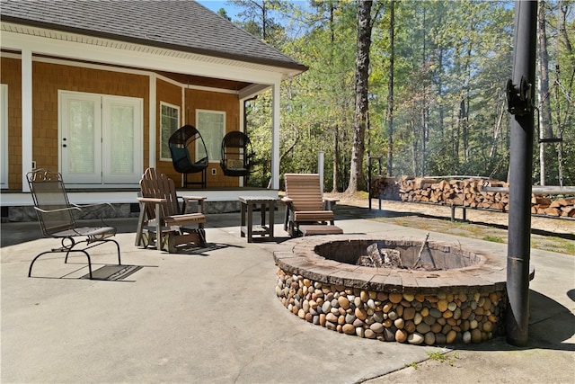 view of patio / terrace featuring french doors and a fire pit