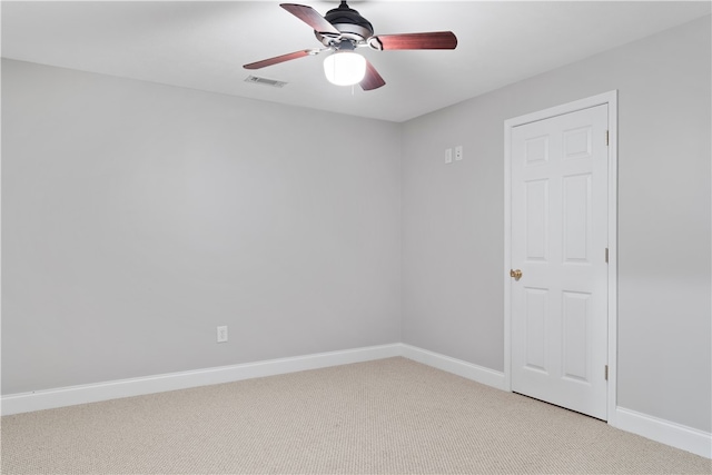 carpeted spare room featuring ceiling fan