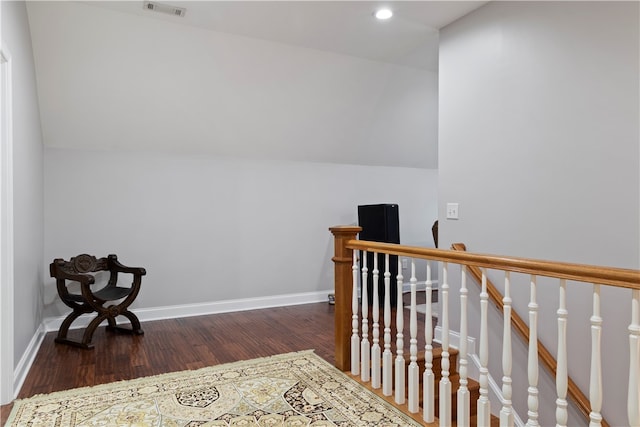 interior space featuring vaulted ceiling and dark wood-type flooring