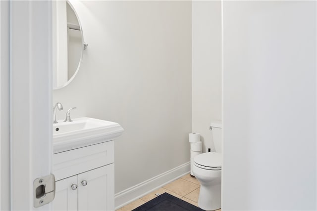 bathroom with tile patterned floors, vanity, and toilet