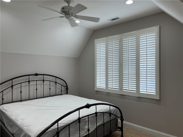 carpeted bedroom with ceiling fan and lofted ceiling