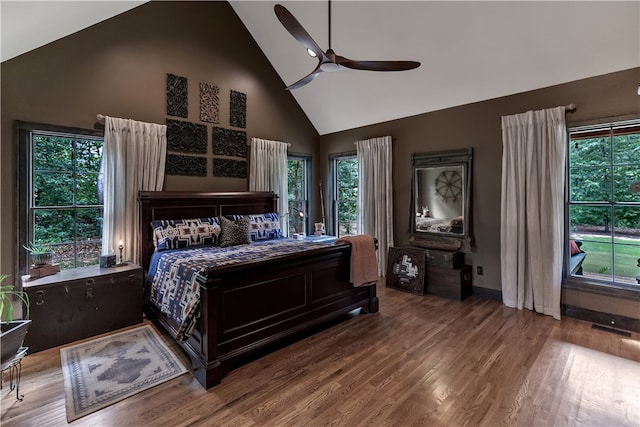 bedroom with ceiling fan, hardwood / wood-style floors, and high vaulted ceiling