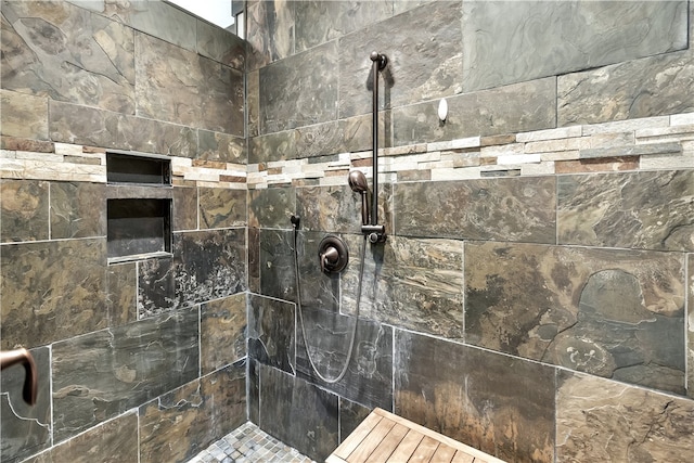 interior details featuring a tile shower