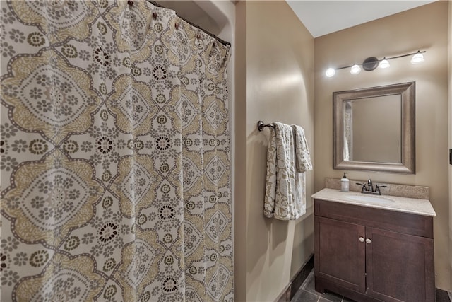 bathroom with tile patterned flooring, a shower with curtain, and vanity