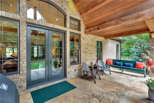 doorway to property featuring a patio, an outdoor living space, and french doors