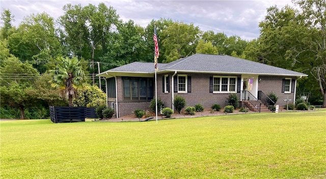 single story home featuring a sunroom and a front lawn