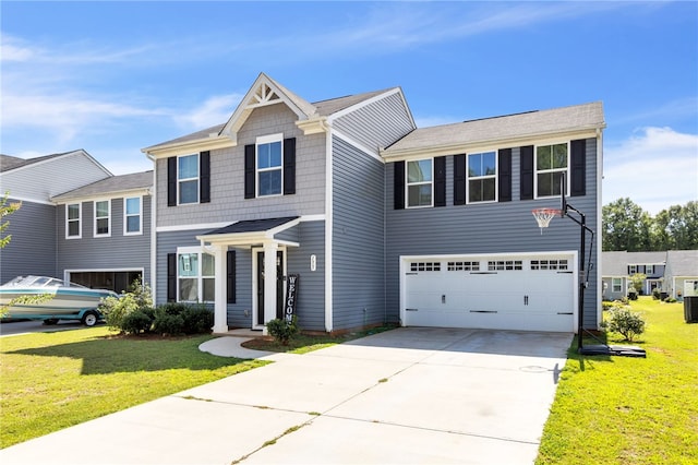 view of front of property featuring a front yard and a garage