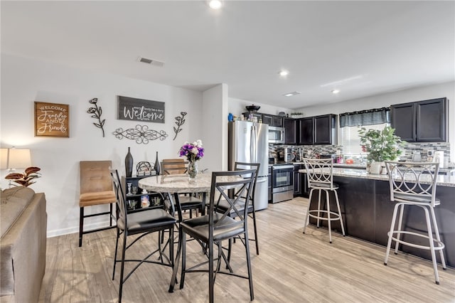 dining area featuring light wood-type flooring