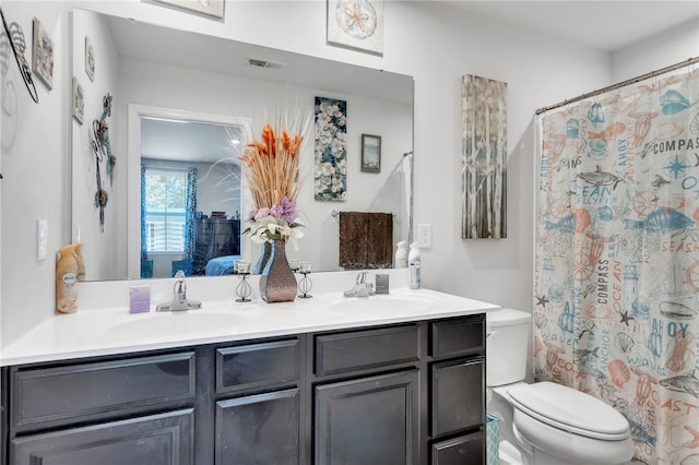 bathroom featuring vanity and toilet