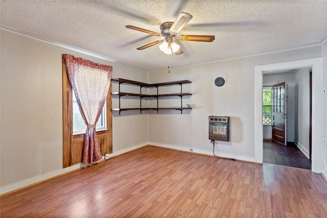 unfurnished room featuring heating unit, crown molding, a textured ceiling, and hardwood / wood-style flooring