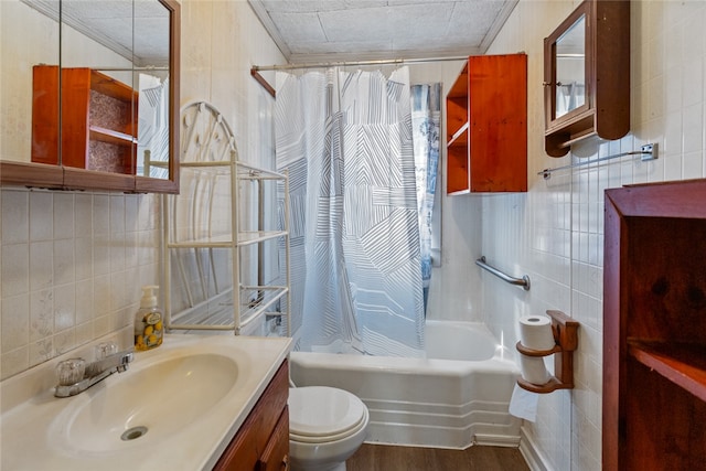 full bathroom with vanity, hardwood / wood-style flooring, shower / bathtub combination with curtain, tile walls, and toilet