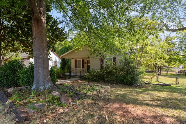 obstructed view of property with a front lawn