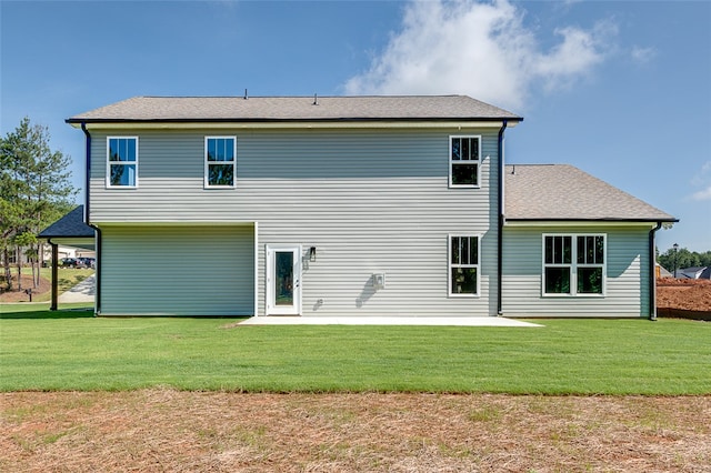 rear view of property with a yard and a patio area