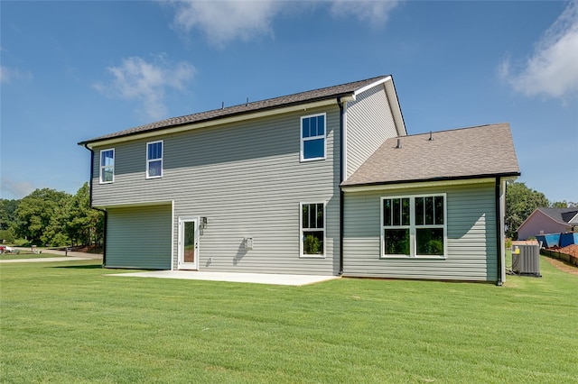 back of house with a yard, a patio area, and central AC