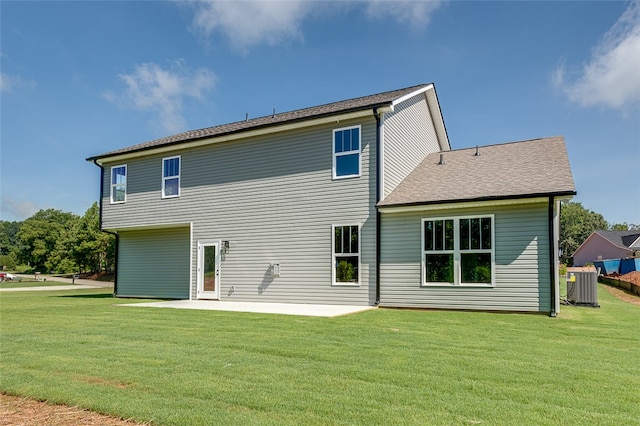 back of house featuring a yard, a patio, and central AC