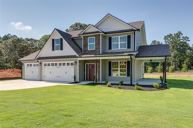 view of front of property with a front yard and a garage