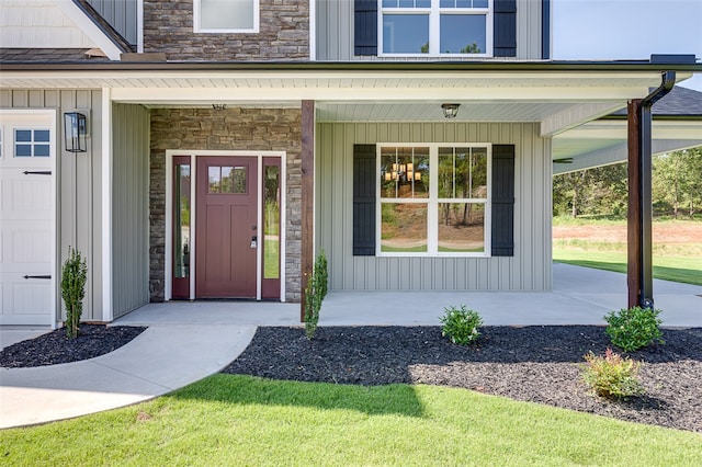 property entrance featuring a garage and a porch