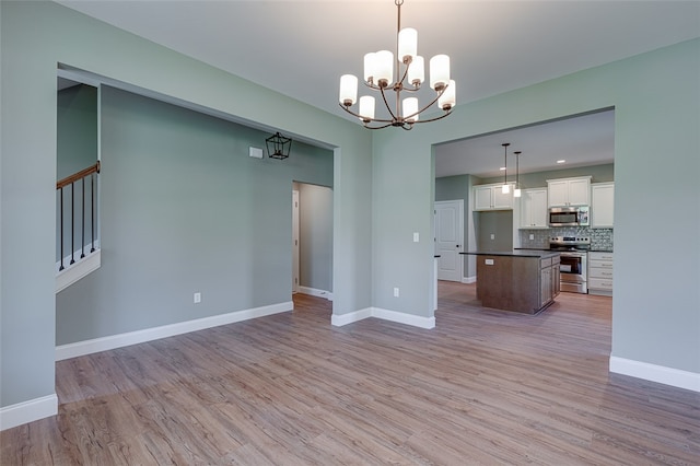 interior space with a chandelier and light hardwood / wood-style floors