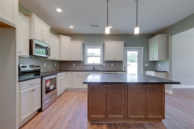 kitchen featuring light hardwood / wood-style floors, white cabinetry, and stainless steel appliances