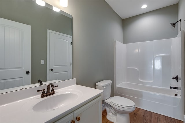 full bathroom featuring bathing tub / shower combination, vanity, toilet, and wood-type flooring