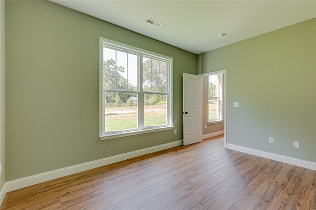 unfurnished room with light wood-type flooring