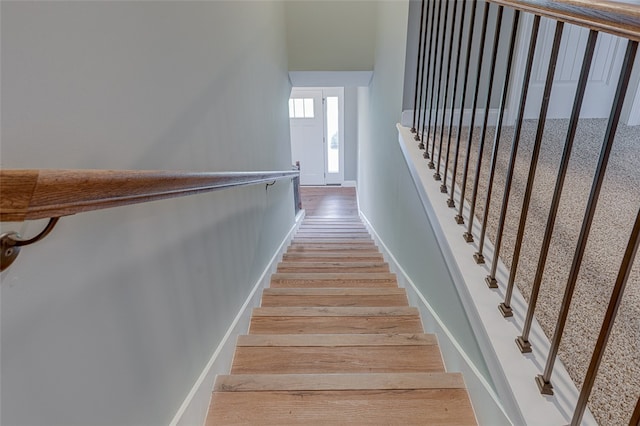 stairs with hardwood / wood-style floors